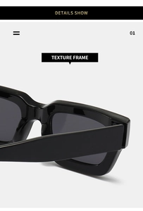 Macro detail of glossy black square frame sunglasses with wide temples and metallic hinge