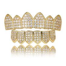 Macro detail of gold-plated hip hop grillz set with sparkling paved zircon stones