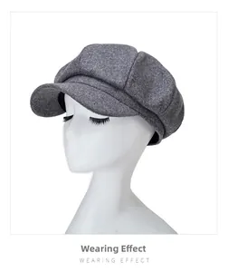 Side view of a grey wool newsboy cap showing the structured fit and wearing effect