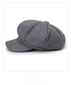 Side view of grey octagonal newsboy cap showing wool texture and panel stitching