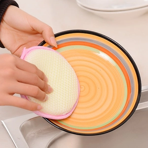 Dual-sided round dishwashing sponge in pink and yellow for efficient kitchen cleaning