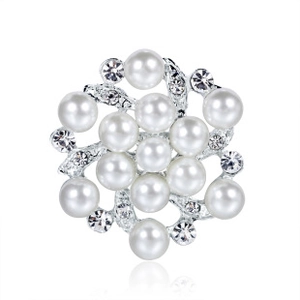 Macro shot of silver flower brooch with white pearls and sparkling crystal rhinestones