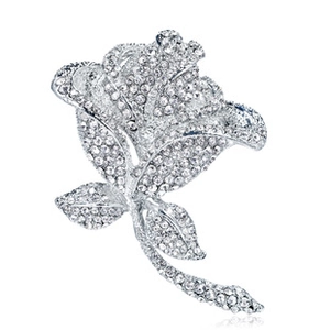 Detailed view of silver-tone rose brooch encrusted with clear sparkling rhinestones