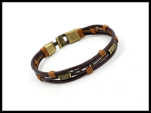 Detail of multi-layer woven leather bracelet with bronze magnetic clasp and metal beads