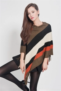 Detailed view of the colorful striped knit pattern and fringe hem on this women poncho