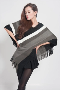 Detail of the black and white striped knitted poncho showing long tassel hem decoration