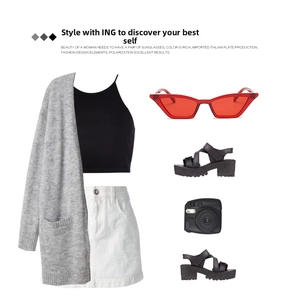 Flat lay of vintage red cat eye sunglasses with grey cardigan and summer outfit set