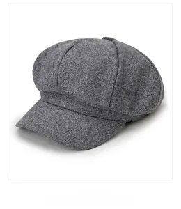 Micro side display of dark grey octagonal newsboy hat showing wool tweed fabric texture