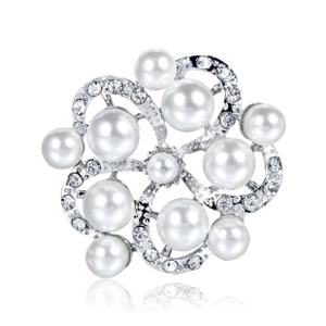 Macro shot of silver flower brooch featuring white pearls and sparkling crystal rhinestones