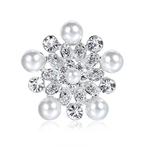 Detailed view of silver snowflake brooch with elegant pearls and crystal rhinestones