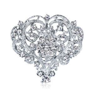 Macro shot of silver heart brooch with hollow filigree and sparkling crystals