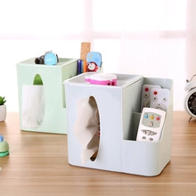 Multifunctional desktop tissue box with compartments for remotes on a wooden desk