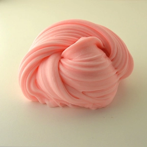 Macro close-up of pink butter slime showing soft swirl texture and stretchy consistency