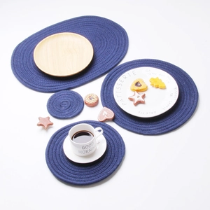 Detailed overhead view of navy blue woven cotton heat-resistant table mats and coasters