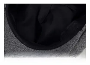 Detailed close-up of breathable black ribbed sweatband and inner lining of wool newsboy cap