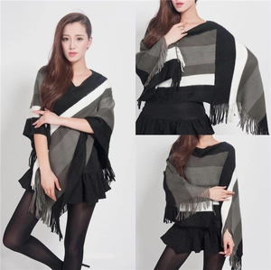Women's striped knit poncho with fringe, black and white color block shawl style