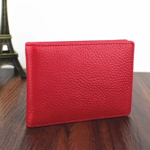 Macro detail of red genuine leather driver's license holder with pebbled texture and stitching