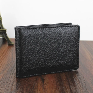 Close-up showing the textured black cowhide finish of a bifold document holder wallet