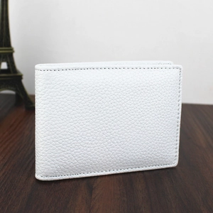 Close-up view of white pebbled genuine leather driver license holder on wooden table