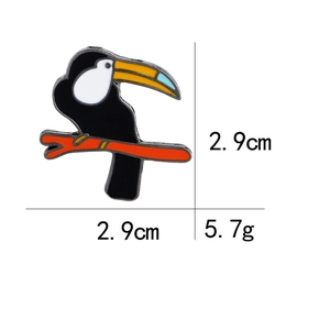 Detailed view of enamel toucan brooch with 2.9cm dimensions and 5.7g weight specs