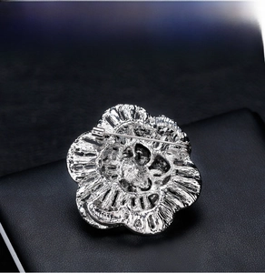 Detailed back view of a silver floral brooch showing the secure pin fastener mechanism