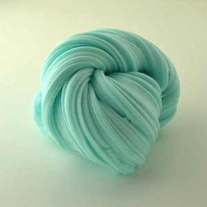 Macro shot of turquoise slime texture with soft swirl patterns and non-stick clay surface