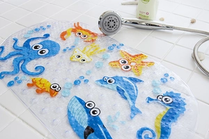 Detail of cartoon sea animal bath mat with powerful suction cups on tile floor
