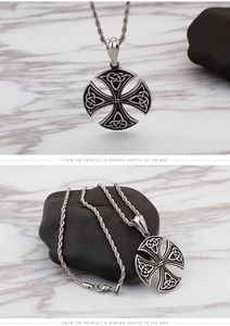Detail of vintage Celtic cross pendant with blackened texture and twisted rope chain