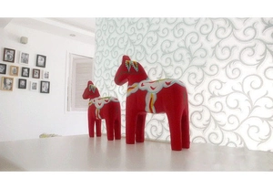 Detail of red Swedish Dala horse figurines with traditional hand-painted floral patterns