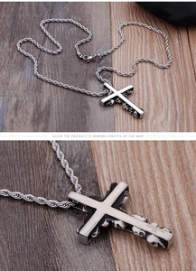 Detail view of 316L stainless steel cross pendant with skull carvings and hallmark