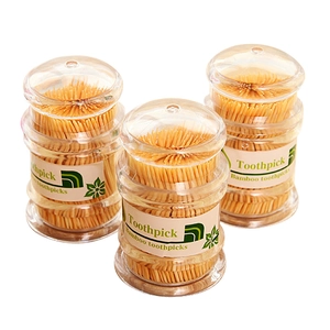 Three jars of double-ended bamboo toothpicks in clear containers with white labels