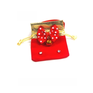 Detailed view of a red velvet New Year lucky bag with golden silk trim and small bell