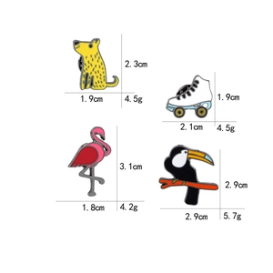 Detail view showing dimensions and weight of enamel flamingo and roller skate pins