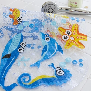 Macro detail of cartoon ocean fish bath mat with non-slip suction cups on tile floor