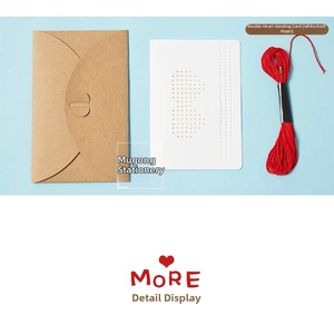 Detailed view of DIY embroidery greeting card kit with kraft envelope and red thread