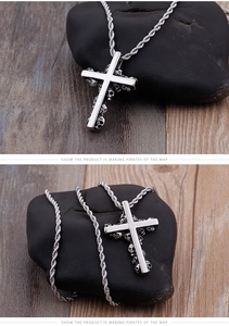 Close-up of vintage titanium steel cross pendant with detailed skull relief and rope chain