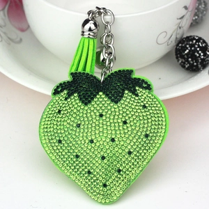 Neon green strawberry keychain with sparkling rhinestones and matching silk tassel charm