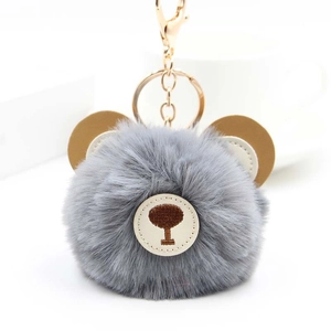 Cute grey fluffy bear pompom keychain with brown leather ears and golden metal clasp