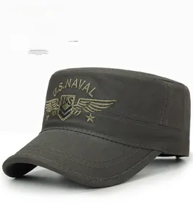 Detail of army green military flat cap showing U.S. NAVAL embroidery and cotton texture
