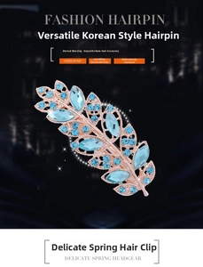 Detailed view of leaf-shaped hair clip with sky blue rhinestones and rose gold base