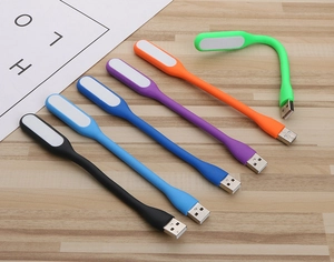 Macro view of colorful flexible silicone USB LED lights arranged on a wooden surface