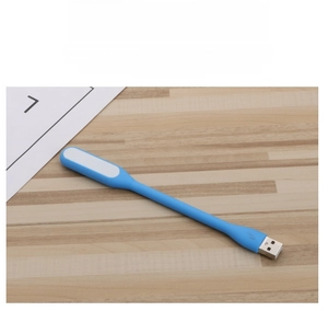 Flexible blue silicone USB LED light showing its slim design on a wooden desk surface