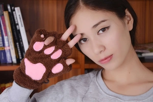 Close-up of brown plush cat paw fingerless gloves featuring soft pink 3D paw pads