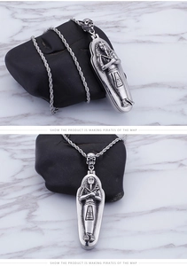 Macro shot of Egyptian mummy coffin pendant with skull bail on twisted rope chain