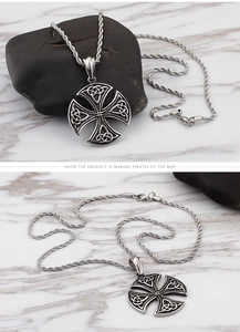 Detail shot of vintage stainless steel Celtic cross pendant with twist chain texture
