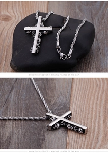 Detailed macro view of a silver stainless steel skull cross pendant on a rope chain