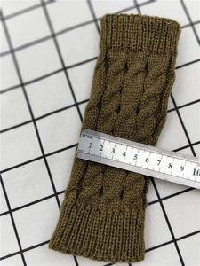 Detailed view of olive green cable knit wrist warmers showing flat width of 8.5 cm
