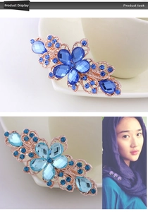 Close-up of vintage flower barrettes with blue crystals and rose gold filigree detail