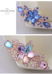 Detail of hollow floral hair clips with multi-colored crystals and rose gold metal base
