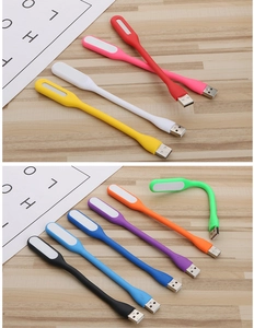 Flexible USB LED night light in various colors shown bent and straight on wood surface